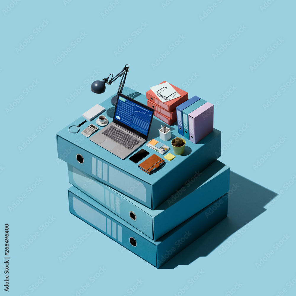 Miniature isometric office on a pile of folders Miniature isometric office on a pile of folders