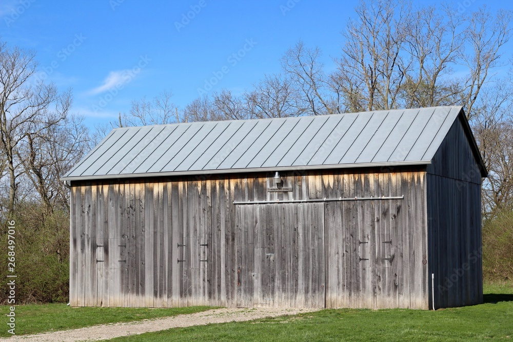 The old wood barn in the country on a bright sunny day. The old wood barn in the country on a bright sunny day.