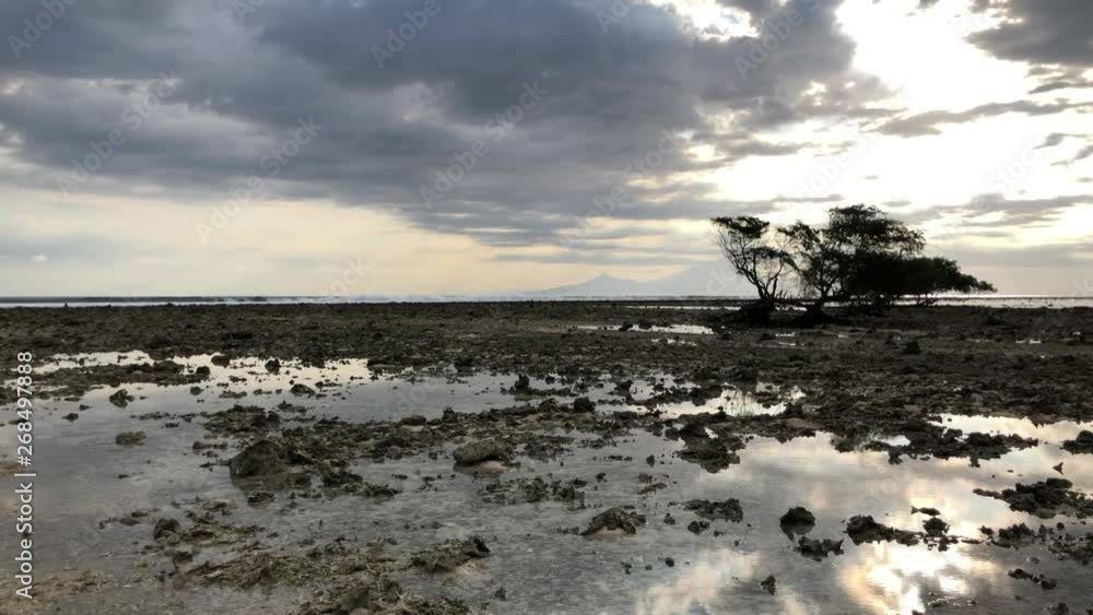 Great low tide on a coral reef in Bali, Indonesia at sunset Great low tide on a coral reef in Bali, Indonesia at sunset