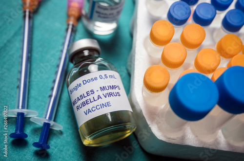Different vials of triple viral vaccine of measles, rubella and mumps, known as MMR, conceptual image photo