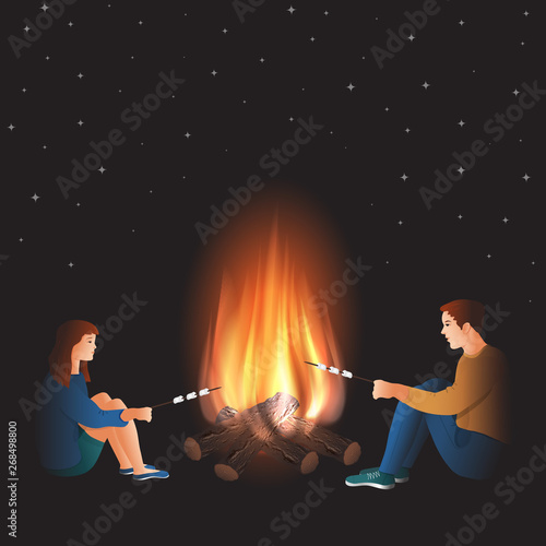 Bonfire with boy and girl cooking marshmallow