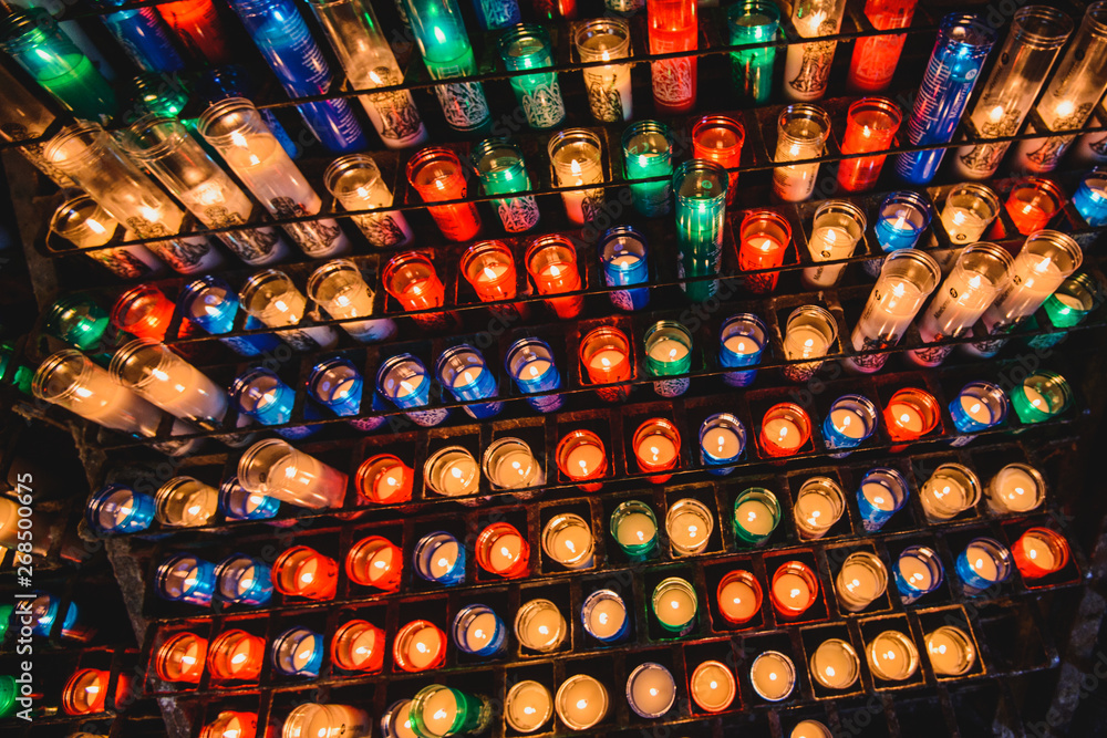 Many colorful candles in the Benedictine abbey Santa Maria de Montserrat 
