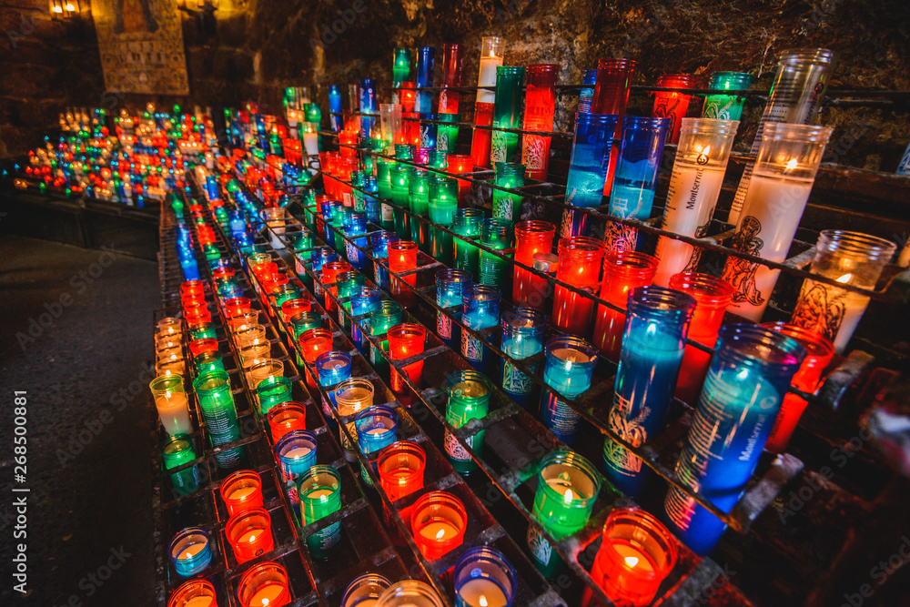Fototapeta premium Many colorful candles in the Benedictine abbey Santa Maria de Montserrat