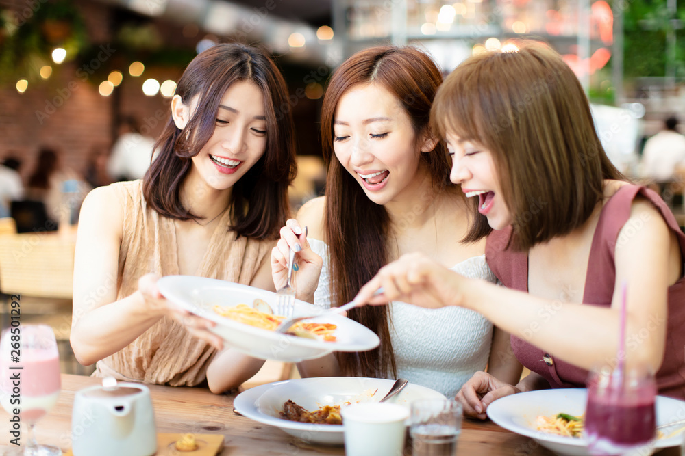 Group of Happy friends having dinner in the restaurant Group of Happy friends having dinner in the restaurant