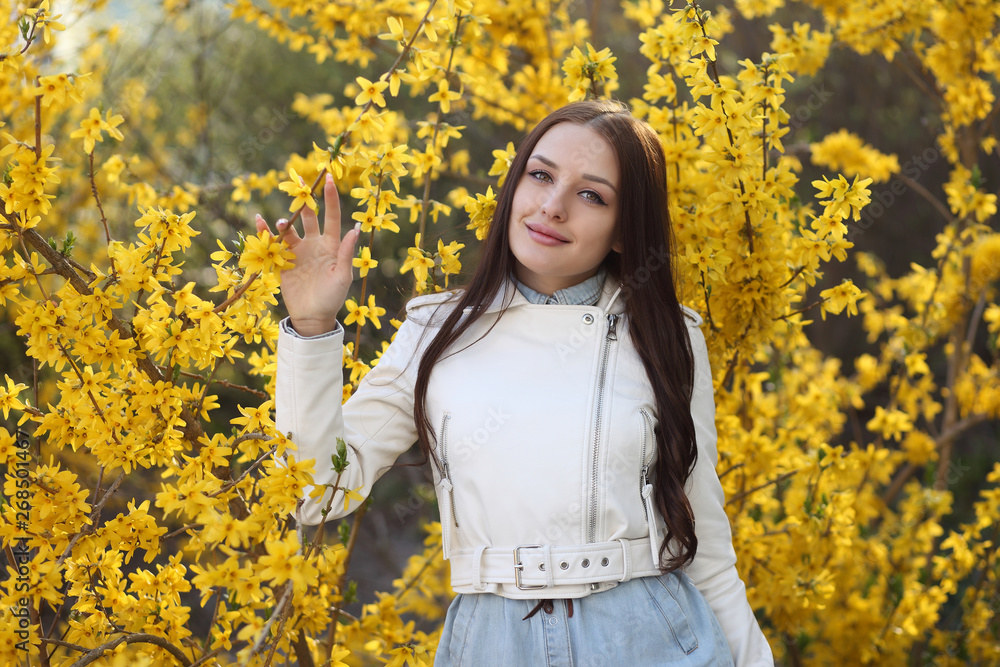 Young girl posing at the bush with spring flowers Young girl posing at the bush with spring flowers