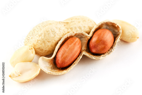 Peanuts closeup in shell and peeled on a white background