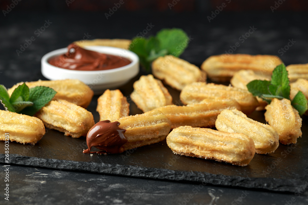 Churros with chocolate dipping sauce. sugar and cinnamon. Churros with chocolate dipping sauce. sugar and cinnamon.