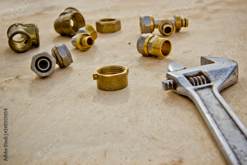 Plumbing concept. tools and pipes on a bright wood table background. Fitting and two adjustable wrenches for plumbing works. Labour day background concept. A concept for Father's Day..