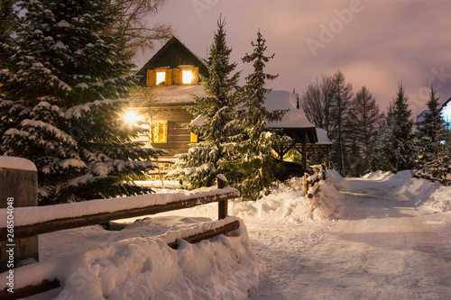 Evening lighted wooden house