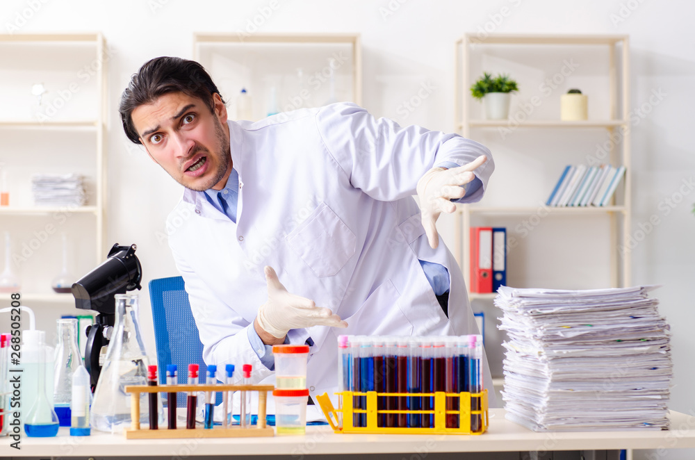 Young male chemist working in the lab Young male chemist working in the lab
