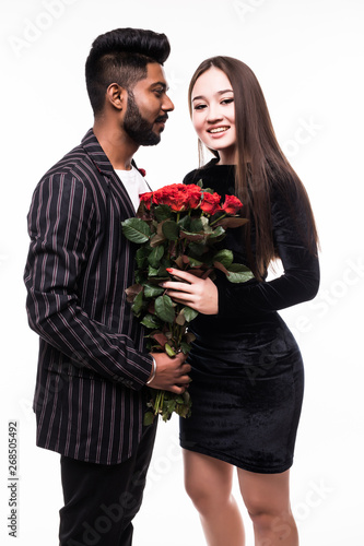 Young asian couple with big red roses isolated on white background, Young indian man give bouquet of roses to his asian woman isolated on white background