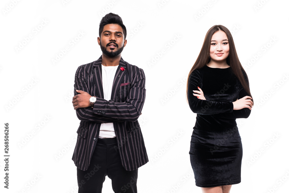 Asian couple in business suits standing together with arms crossed on white background