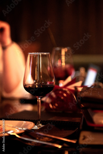 A glass of red wine on the table in the restaurant