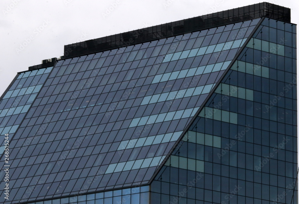 Beautiful photos of modern buildings under blue sky. Sky reflecting in windows of office building