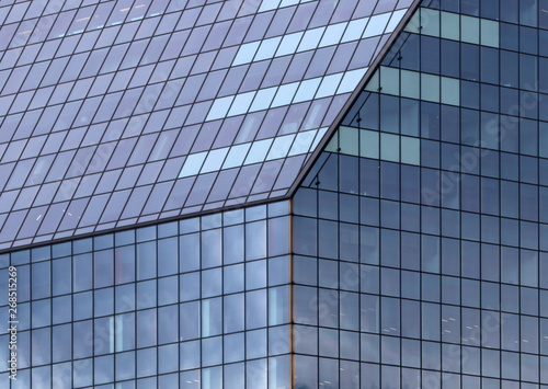 Beautiful photos of modern buildings under blue sky. Sky reflecting in windows of office building
