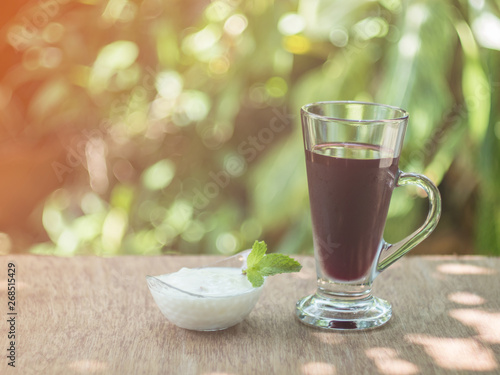 berry juice with yogurt on green background, healthy concept