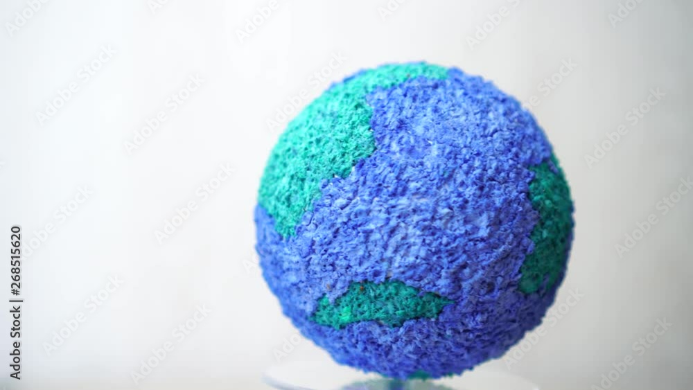 creating rotating of models paper craft earth globe, Spinning world global ecology on gray background. loop created in 4K creating rotating of models paper craft earth globe, Spinning world global ecology on gray background. loop created in 4K