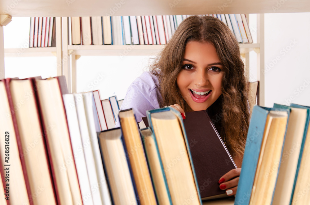 Young female student preparing for exams at library Young female student preparing for exams at library