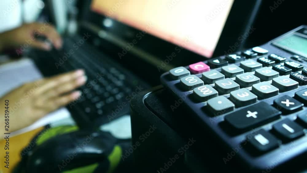 Business accounting concept, Business woman using calculator with computer laptop, budget and loan paper in office footage 4K