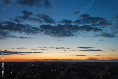 Colorful sunset. Clouds in the evening sky. View from the roof of a multistory building. Ukraine © Roman