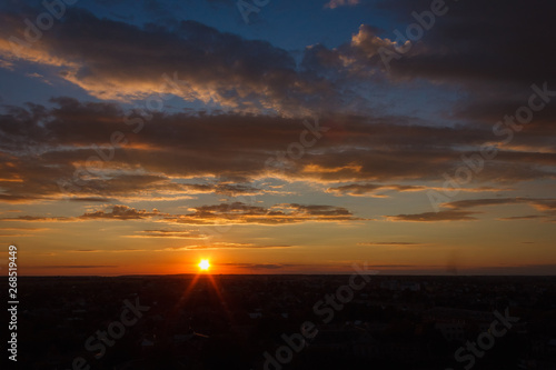 Colorful sunset. Clouds in the evening sky. View from the roof of a multistory building. Ukraine
