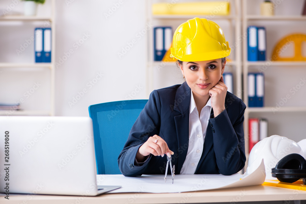 Young female architect working in the office Young female architect working in the office
