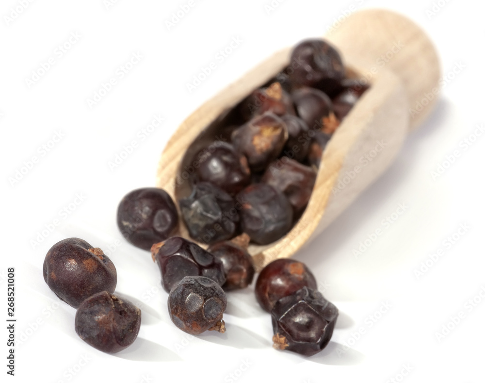 Fototapeta premium Dried juniper berries isolated on white. Soft focus view. Close up.