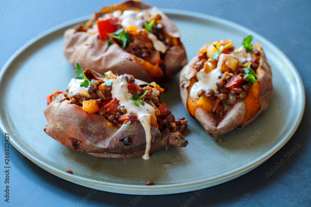 Sweet potatoes with spicy lentils, yellow pepper and tomato filling, thyme, garlic flowers and chipotle sour cream 