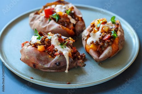 Sweet potatoes with spicy lentils, yellow pepper and tomato filling, thyme, garlic flowers and chipotle sour cream 