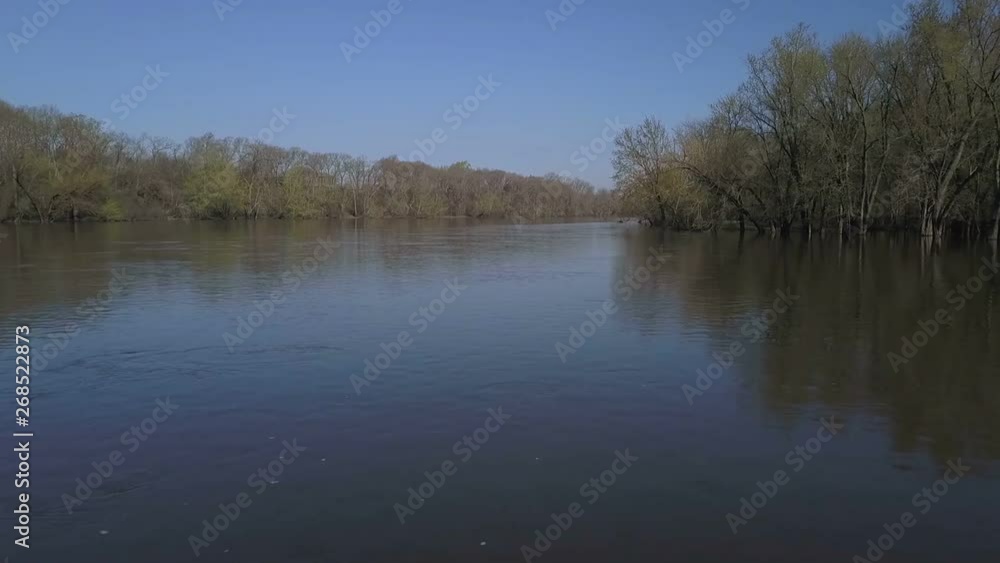 Aerial flying low over a river through a forest Aerial flying low over a river through a forest