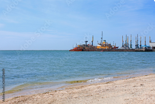 Fototapeta Naklejka Na Ścianę i Meble -  Sea port view. Ships at the pier of Azov Sea, Ukraine, seascape, nature background, copy space.