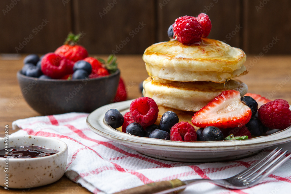 Tasty fluffy pancakes with berries Tasty fluffy pancakes with berries