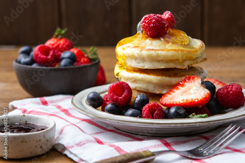 Tasty fluffy pancakes with berries