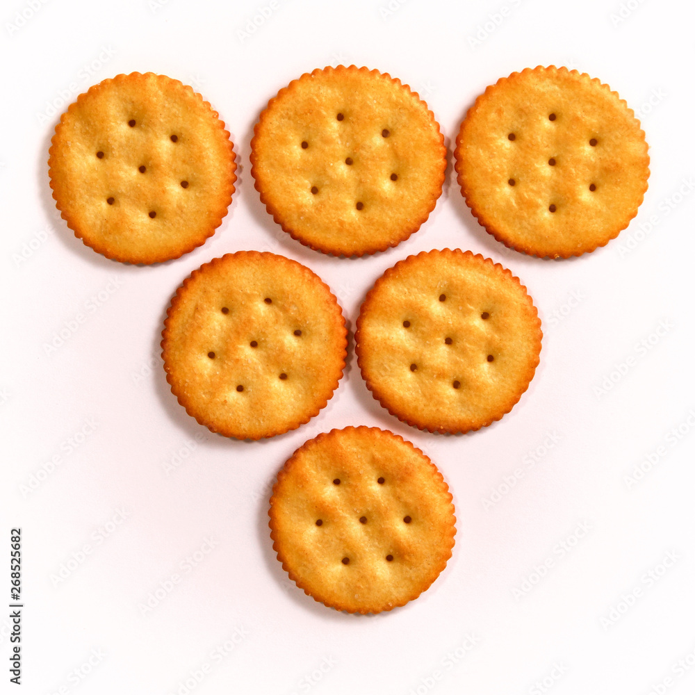 inverted triangle of six round crackers on white, in three rows, learning to count concept.