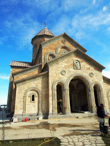 ancient monastery of Bodbe in Georgia lit by the morning sun photo