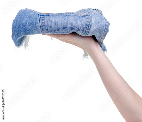Denim shorts in the hands on a white background. Isolation