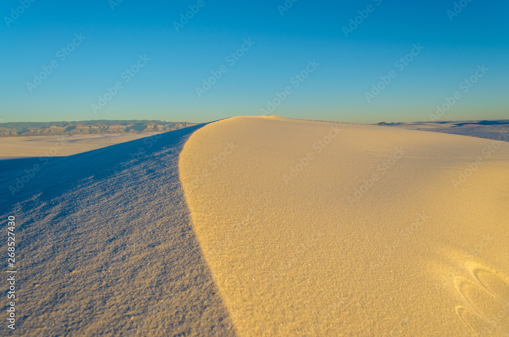 A Sand Dune in a Desert during Sunset