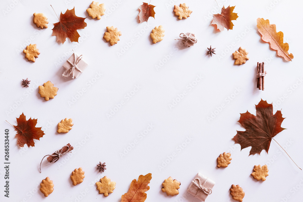 Hello Autumn flat lay background. Top view of wreath with maple leaves and yellow flowers, honey biscuits and cookies. Hello Autumn flat lay background. Top view of wreath with maple leaves and yellow flowers, honey biscuits and cookies.
