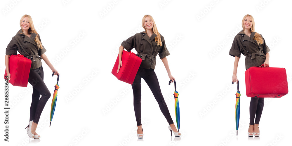 Obraz premium Young beautiful woman with suitcase and umbrella isolated on whi