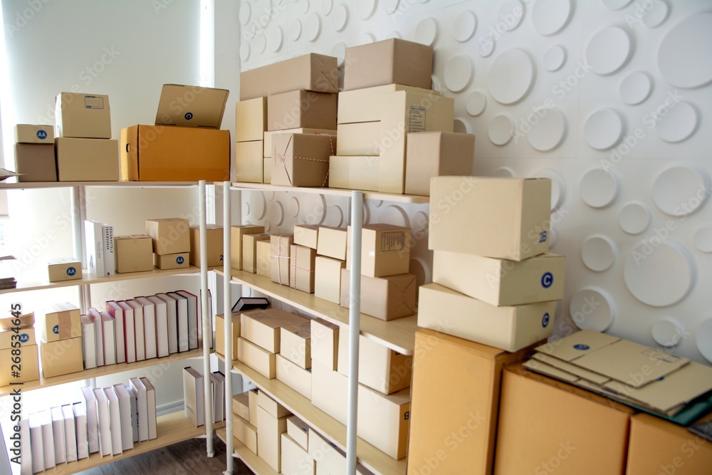 Group of composite cardboard boxes and file folders boxes on pallet by rack