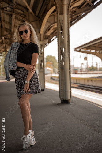 the girl at the station posing in front of a train ride