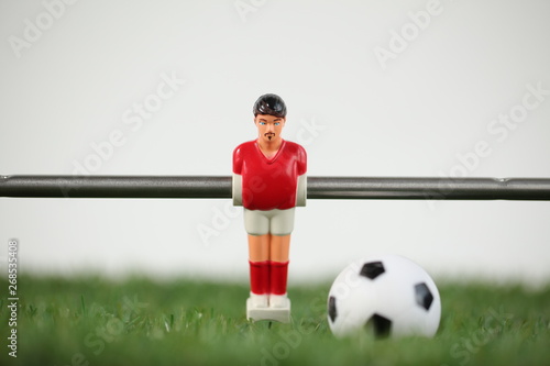 Red foosball plastic players. Soccer ball