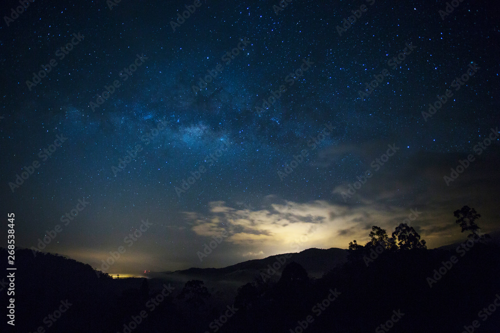 Starry night, beautiful milky-way cross the night sky over the hill.