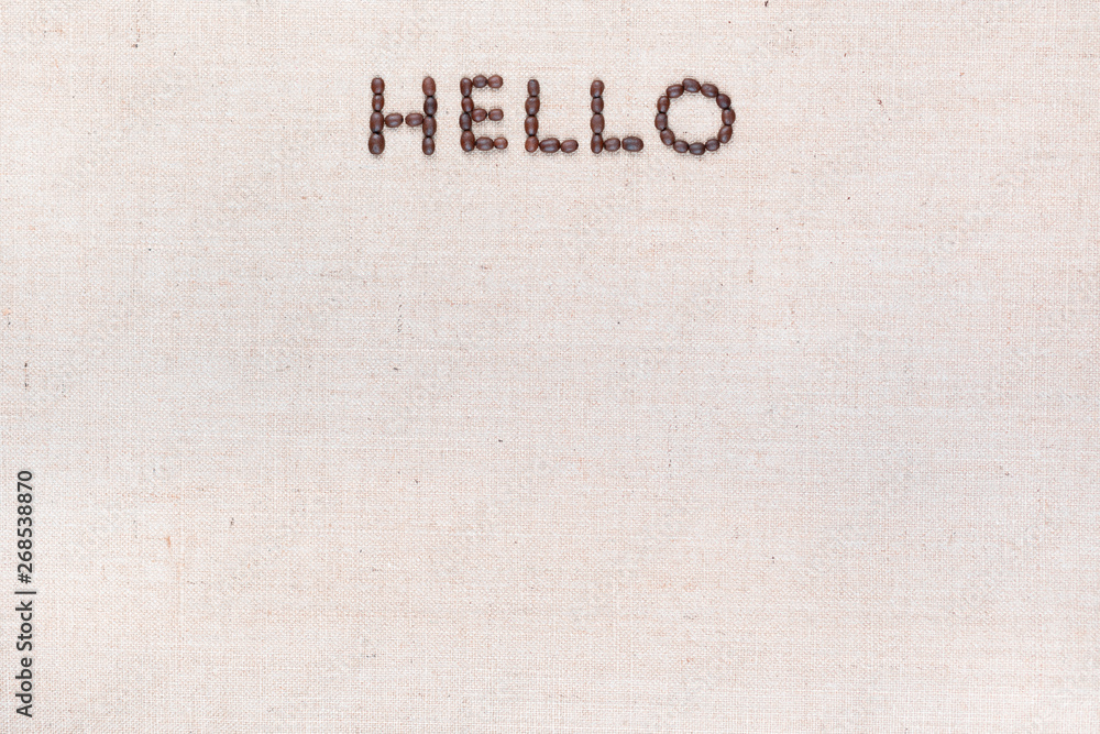 The word Hello written with coffee beans shot from above, aligned at the top.