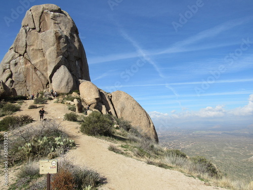 View at the peak of Tom's Thumb with tourists and hikers in the McDowell Mountain range in the Sonoran Desert