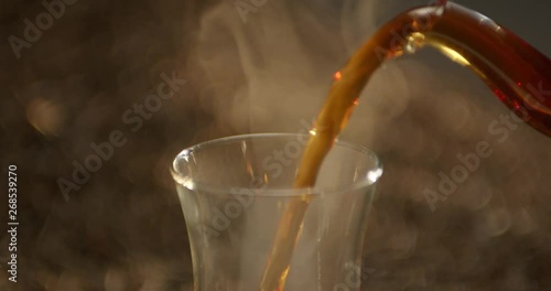 Pouring tea into the cup with teapot and tea leaves at the background. Alexa Plus Camera 