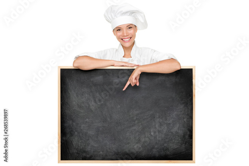 Obraz na plátně Chef poitnting at menu chalkboard black board with top hat showing today specials at restaurant
