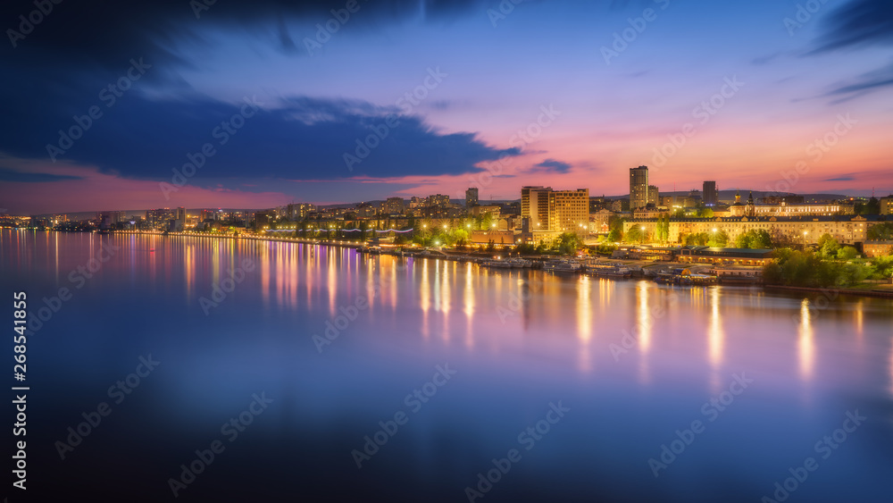 Saratov city skyline at sunset, panoramic view to quay from the bridge on Volga river. Russia