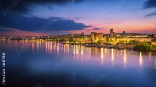 Saratov city skyline at sunset, panoramic view to quay from the bridge on Volga river. Russia