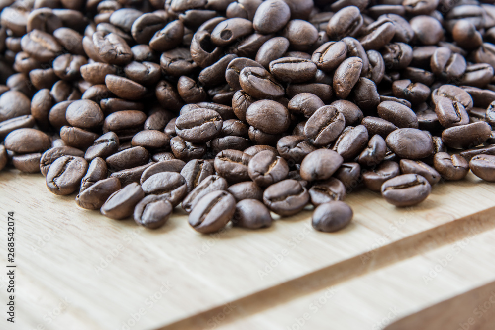 Roasted coffee beans on wood tables and copy space
